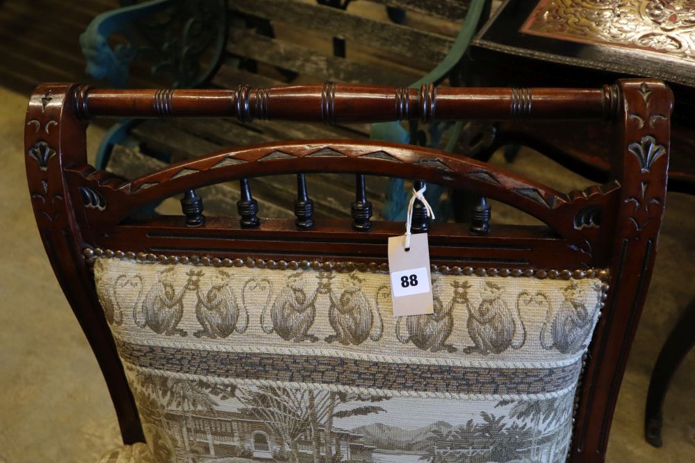 A Victorian aesthetic movement inlaid mahogany armchair, with later elephant pattern upholstery, width 68cm height 93cm